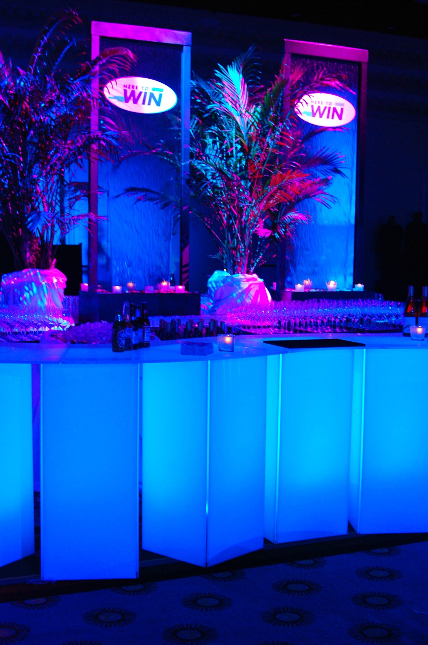 Two decaled water walls on a table behind an acrylic LED light up bar.