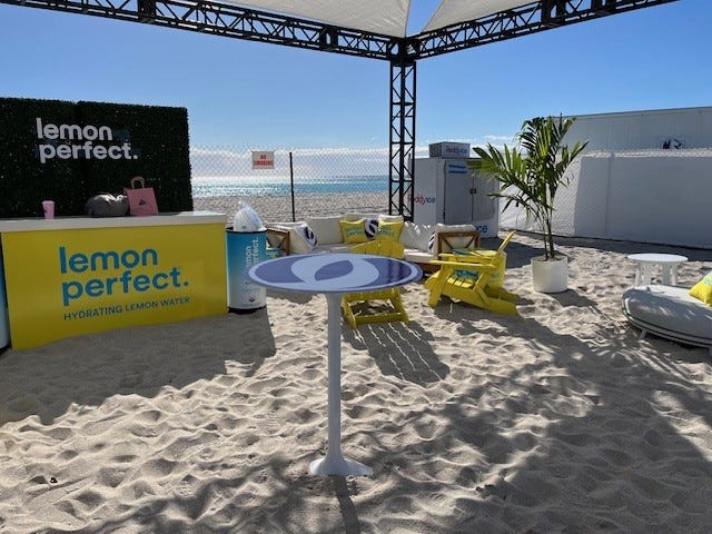 Graphic Decal Logo on White Sutton High Top Table at the beach.