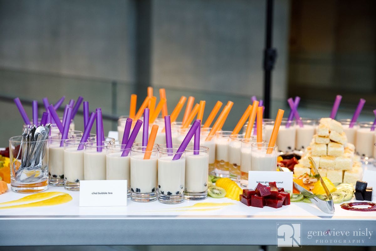 Grab and go drinks and finger foods on a white communal table