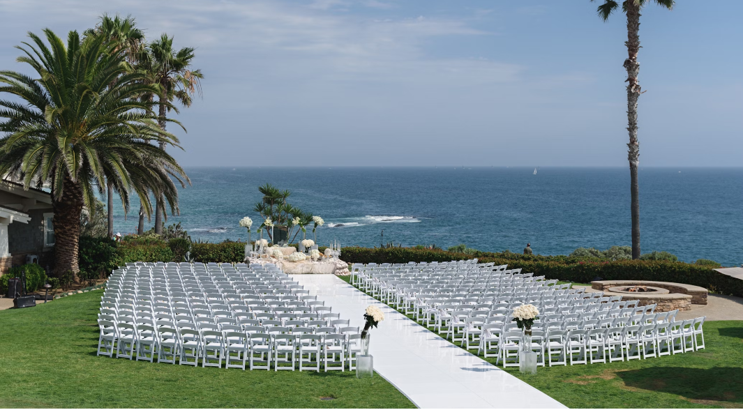 White Padded Folding Chairs at an outdoor wedding