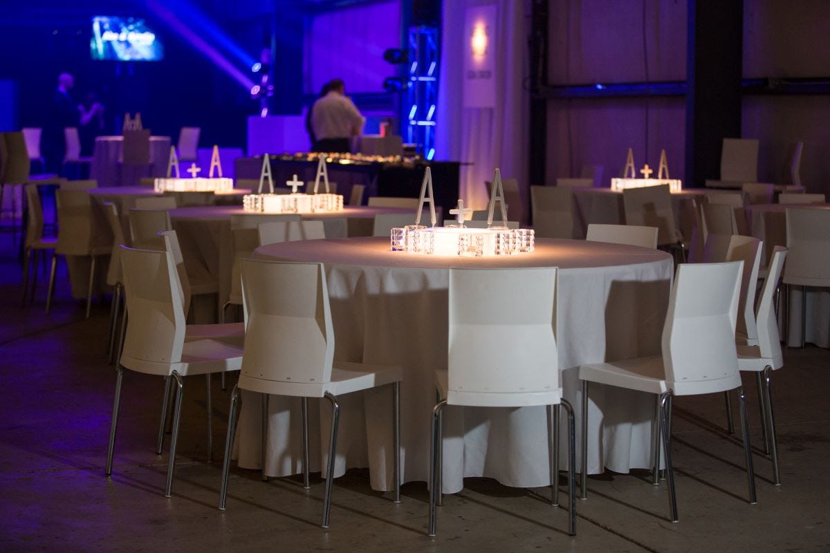 White Simon Chairs set at Round Tables with White Linen